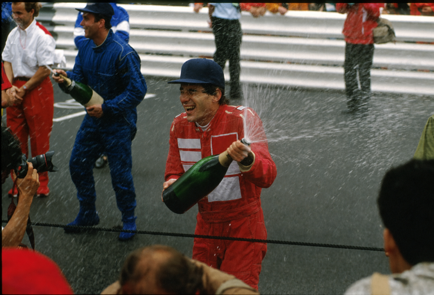 Ayrton Senna celebrating on the podium at Monaco